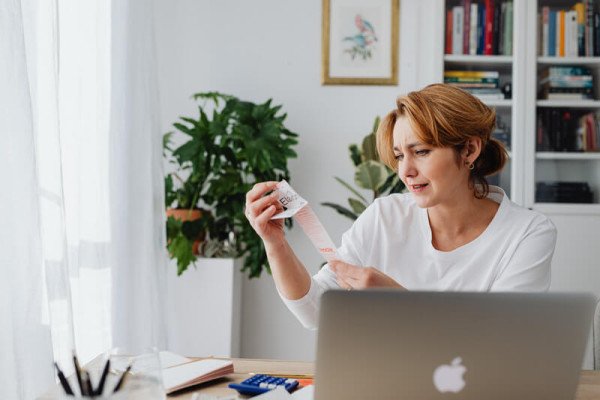 A woman looking at receipt paper